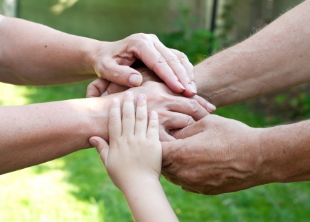 Family holding hands together outdoorの写真素材