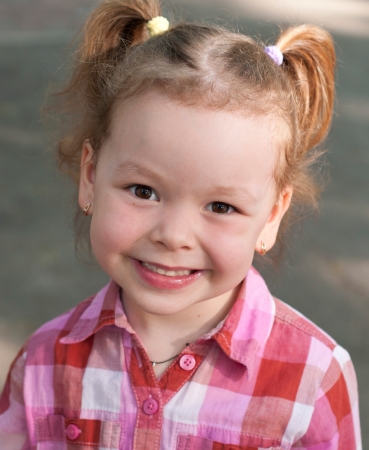 happy smile liitle girl close-up in parkの写真素材