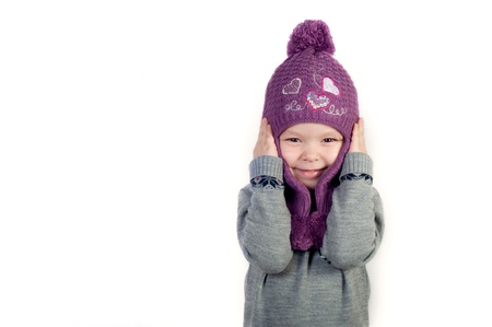 Little girl in hat and in winter clothesの写真素材