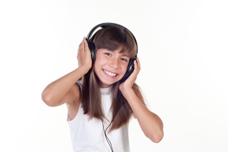 Beautiful cute happy little girl with headphonesの写真素材