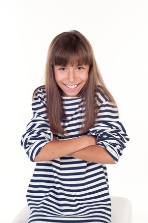 Portrait of a beautiful little girl with folded hands over white backgroundの写真素材