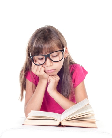 little girl with books wearing glasses, back to school concept, isolated over whiteの写真素材