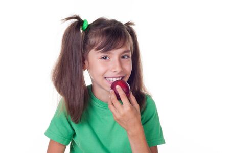 A little girl eating plum  on white backgroundの写真素材