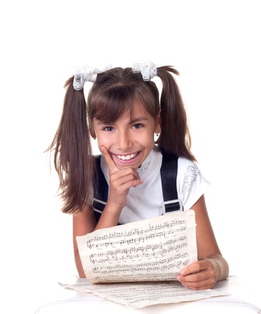 Cute little girl with books. School portrait. Isolated on white backgroundの写真素材