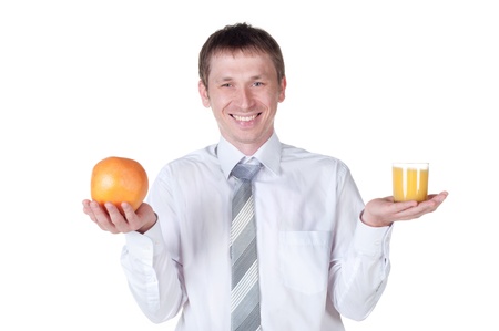 Man showing glass of orange juice and fruit to the camera  Isolated on whiteの写真素材