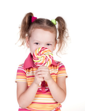Cute little girl holding big lolly pop isolated in whiteの写真素材