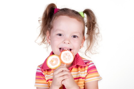 Cute fun little girl holding lolly pop on white backgroundの写真素材