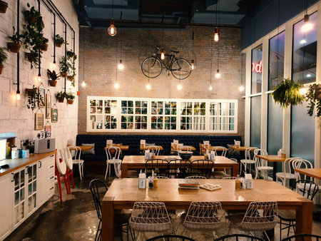 Interior of a cafe with tables, chairs, chairs and decorationsの写真素材