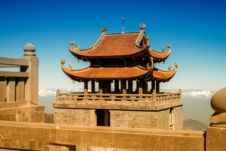 The grand bell tower of Thanh Van Dac Lo Spiritual Landmarks, with scenic misty mountain view as background, at Fansipan peak,Vietnamのeditorial素材