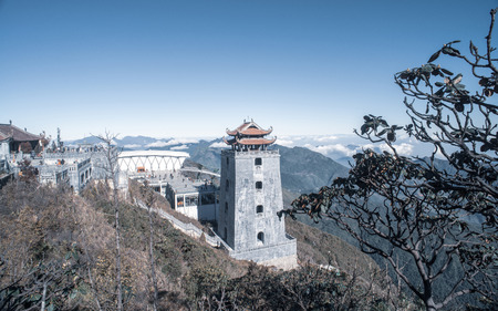 The grand bell tower of Thanh Van Dac Lo Spiritual Landmarks, with scenic misty mountain view as background, at Fansipan peak,Vietnamのeditorial素材