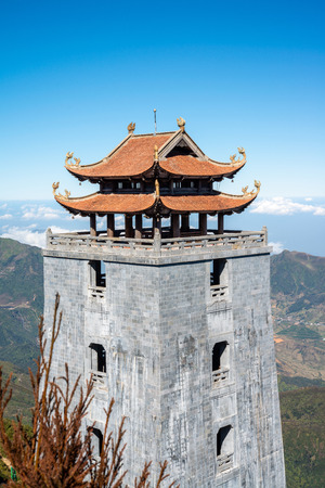 The grand bell tower of Thanh Van Dac Lo Spiritual Landmarks, with scenic misty mountain view as background, at Fansipan peak,Vietnamのeditorial素材