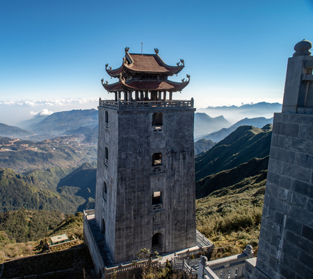 The grand bell tower of Thanh Van Dac Lo Spiritual Landmarks, with scenic misty mountain view as background, at Fansipan peak,Vietnamのeditorial素材