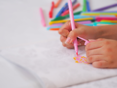 Hands colouring/coloring on peper with variety colour pen backgroundの写真素材
