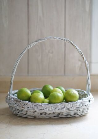 Lime in White Basket in the Kitchenの写真素材
