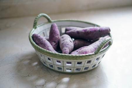purple sweet potato in a basketの写真素材