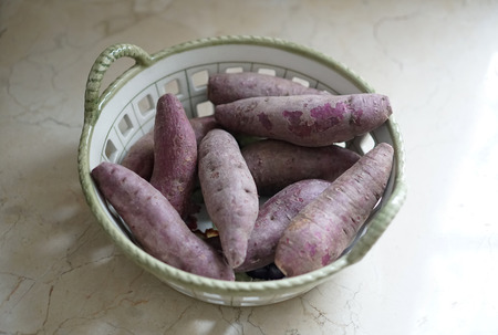 purple sweet potato in a basketの写真素材