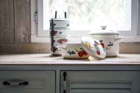 Vintage cooking pot and tiffin carrier set on the kitchen table