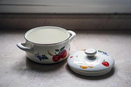 Vintage cooking pot on the kitchen tableの写真素材