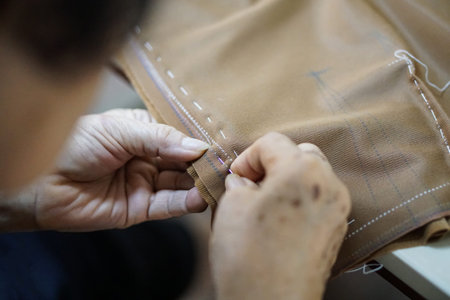 grandma hand needle and sewing making cloth
