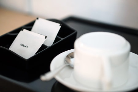 white sugar packet with coffee cup and kettle set in hotel room