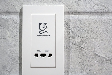 white shavers only sign electrical outlet in restroom