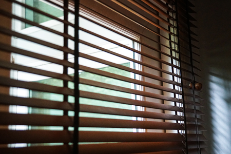 wood blind shade curtain and shadowの写真素材