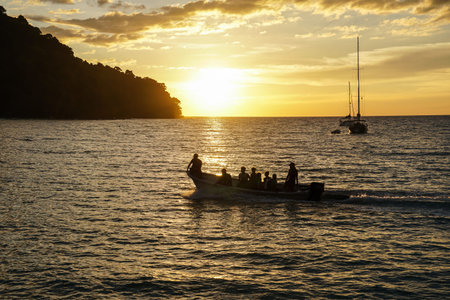 koh kood beach thailand, sunset boat orange sky people on boat, kayaking silhouetteの写真素材