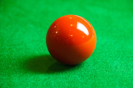 red snooker ball on snooker table