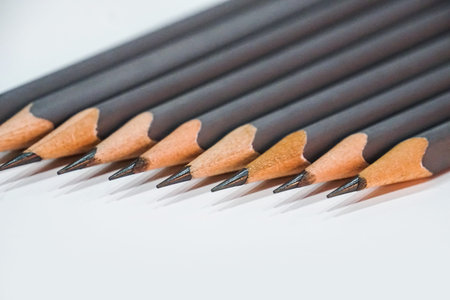 sharp grey pencils on white table background