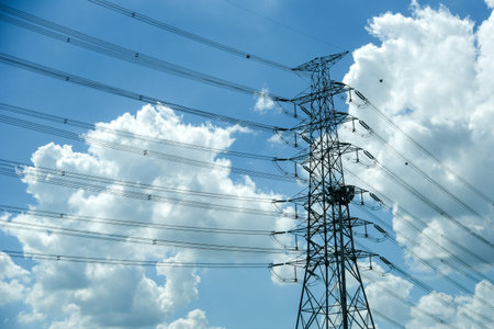 high voltage power electric pole wire blue cloudy sky