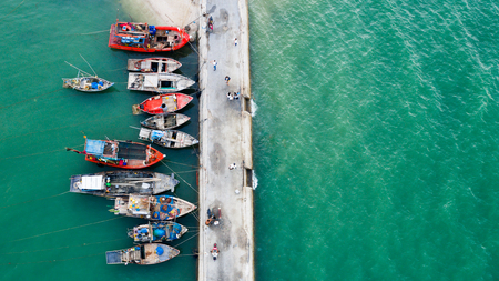 A fishing boat parking on a fishing harbour bridgeのeditorial素材