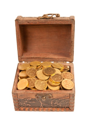 an old trunk with shiny coins isolated on white backgroundの写真素材