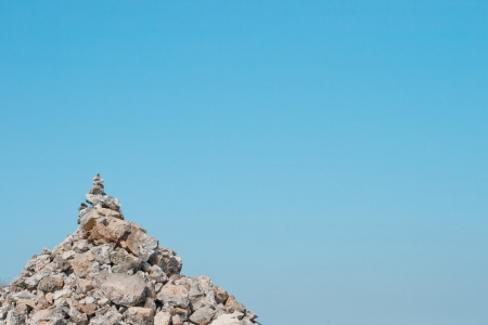 One pyramid of stones against the blue sky backgroundの写真素材