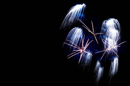 Silver fireworks on the black sky background with copyspace for textの写真素材