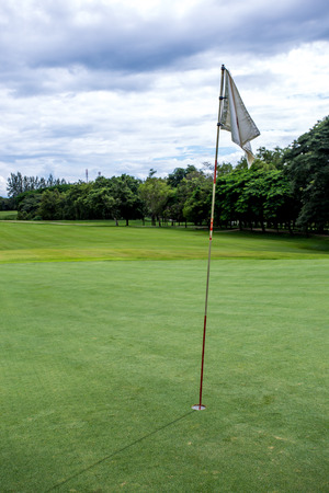 a golf flag on the gold courseの写真素材
