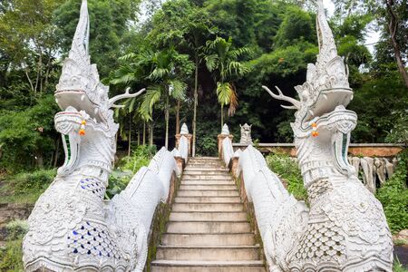 The Serpent statue naga on the ladder at the entrance to Thai templeの写真素材