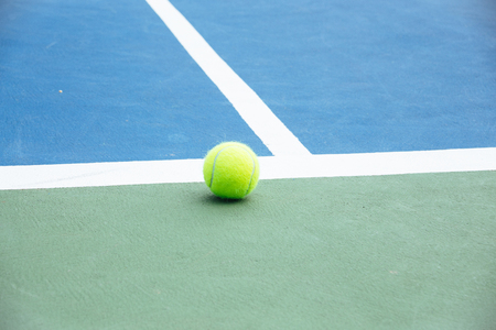 blue and green tennis court surface,Tennis ball on the field.の写真素材