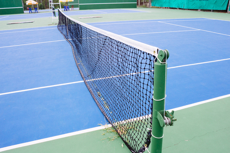 blue and green tennis court surface,Tennis ball on the field.の写真素材