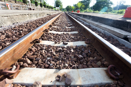 walk alone on railroad tracks at  train stationの写真素材
