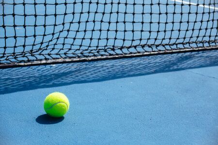 blue and green tennis court surface,Tennis ball on the field.の写真素材
