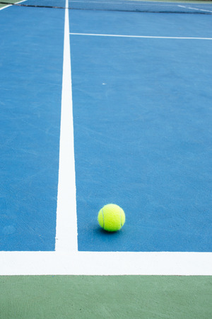 blue and green tennis court surface,Tennis ball on the field.の写真素材