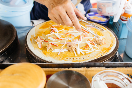 Making crepe pizza egg  tuna crispy pancake.の写真素材