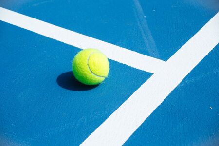 blue and green tennis court surface,Tennis ball on the field.の写真素材