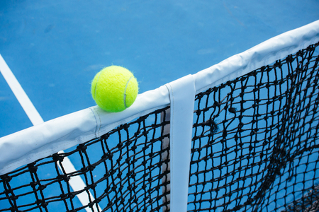 blue and green tennis court surface,Tennis ball on the field.の写真素材