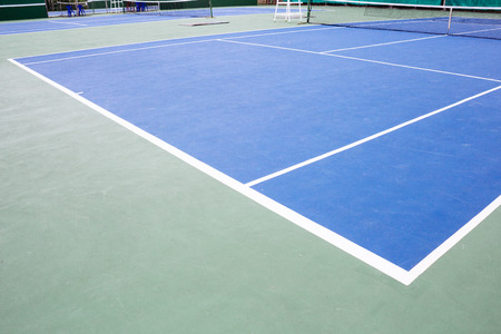 blue and green tennis court surface,Tennis ball on the field.の写真素材