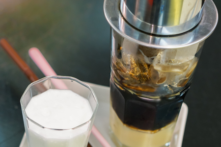 Close-up Vietnamese Drip Coffee and Ice mug served with milk, Iced black coffee.の写真素材