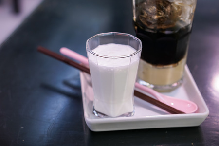 Close-up Vietnamese Drip Coffee and Ice mug served with milk, Iced black coffee.の写真素材