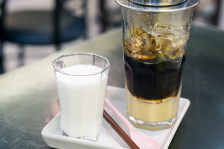Close-up Vietnamese Drip Coffee and Ice mug served with milk, Iced black coffee.の写真素材