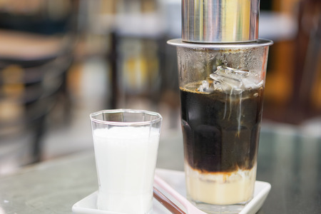 Close-up Vietnamese Drip Coffee and Ice mug served with milk, Iced black coffee.の写真素材