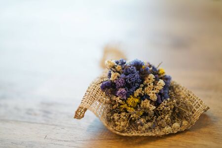 Beautiful dry grass flowers placed on a wooden table in the living room.の写真素材